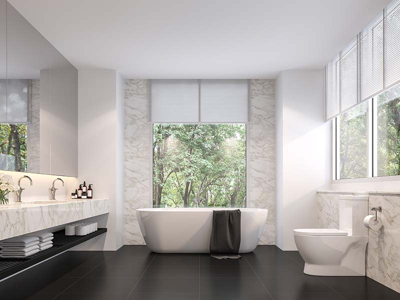 Bathroom with a freestanding tub in front of a large window